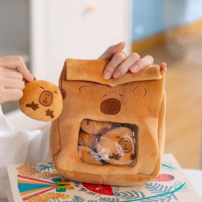 Brown kawaii capybara shaped bag held by a person with a colorful background