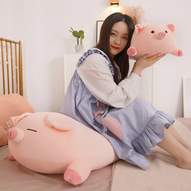 Woman holding a large pink pig kawaii plush toy in a cozy room.