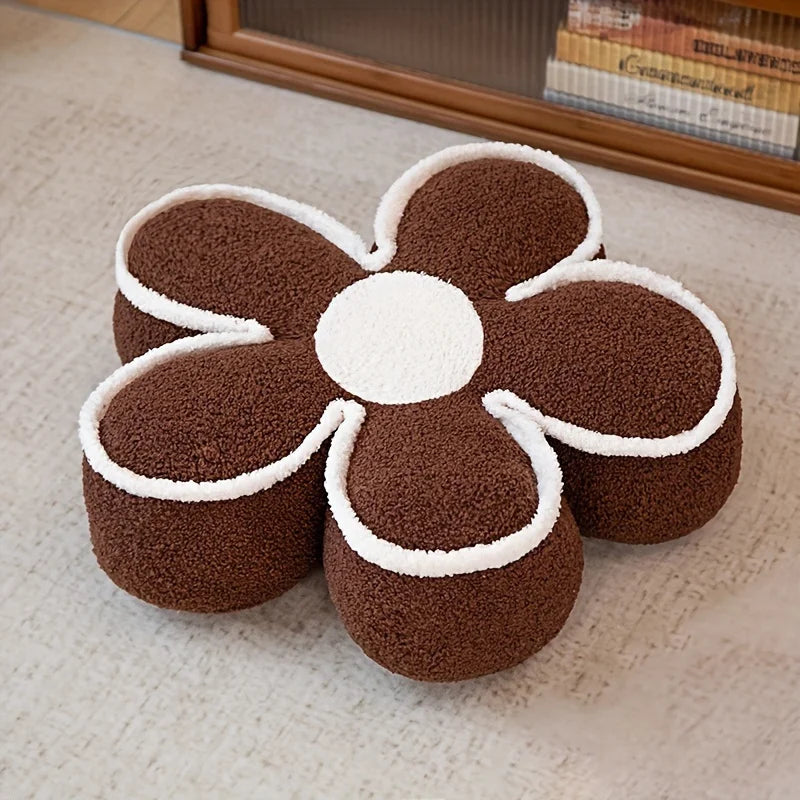 Flower-shaped brown and white kawaii cushion on a textured surface