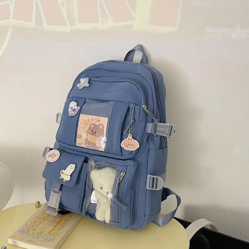 Kawaii blue backpack with decorative elements on a light surface