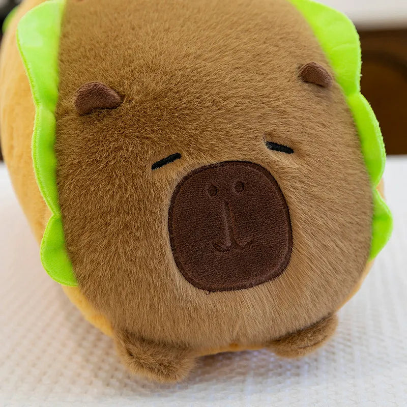 Kawaii plush toy resembling a bear in a taco with green shell on a white background