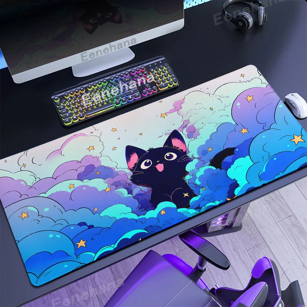 Desk setup with a large mouse pad featuring a Kawaii black cat design, keyboard, and monitor.