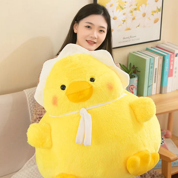 Person holding a large yellow kawaii plush duck toy in a room with books and decor.