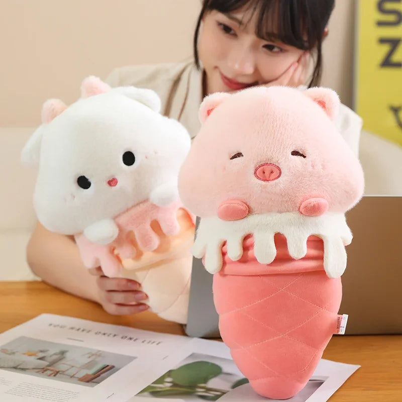Two kawaii plush ice cream toys shaped like pigs held by a person on a table with a magazine underneath.