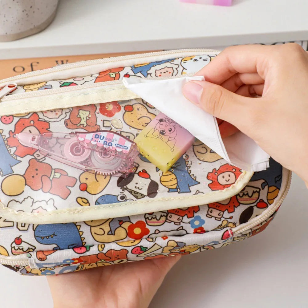 Colorful kawaii cartoon-patterned pouch with stationery items being taken out.