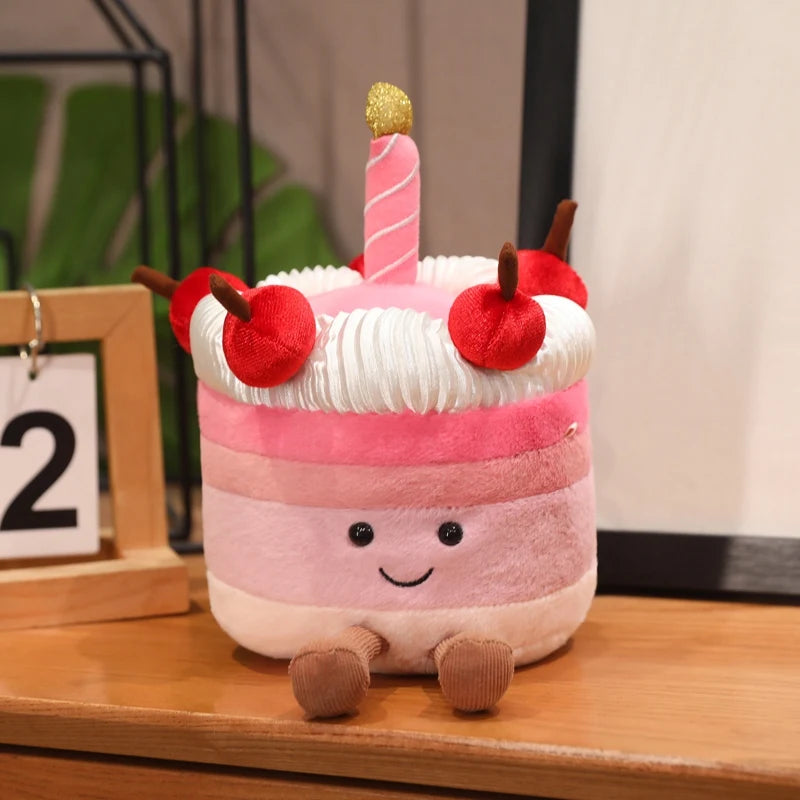 Plush kawaii toy cake with a candle on a wooden surface