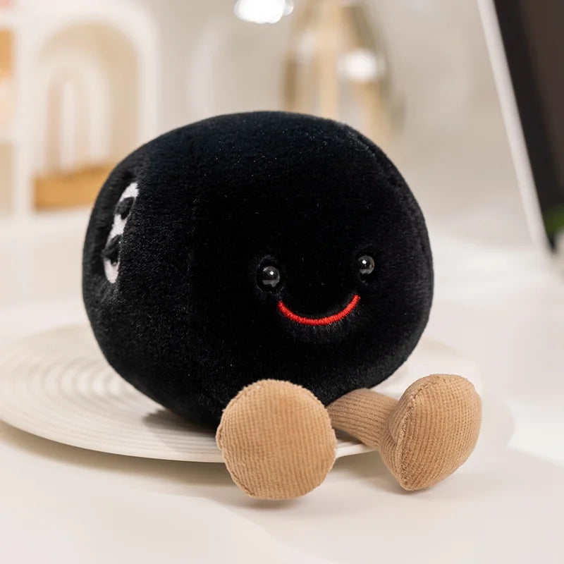 Black plush kawaii toy with a smiling face and beige legs on a white surface