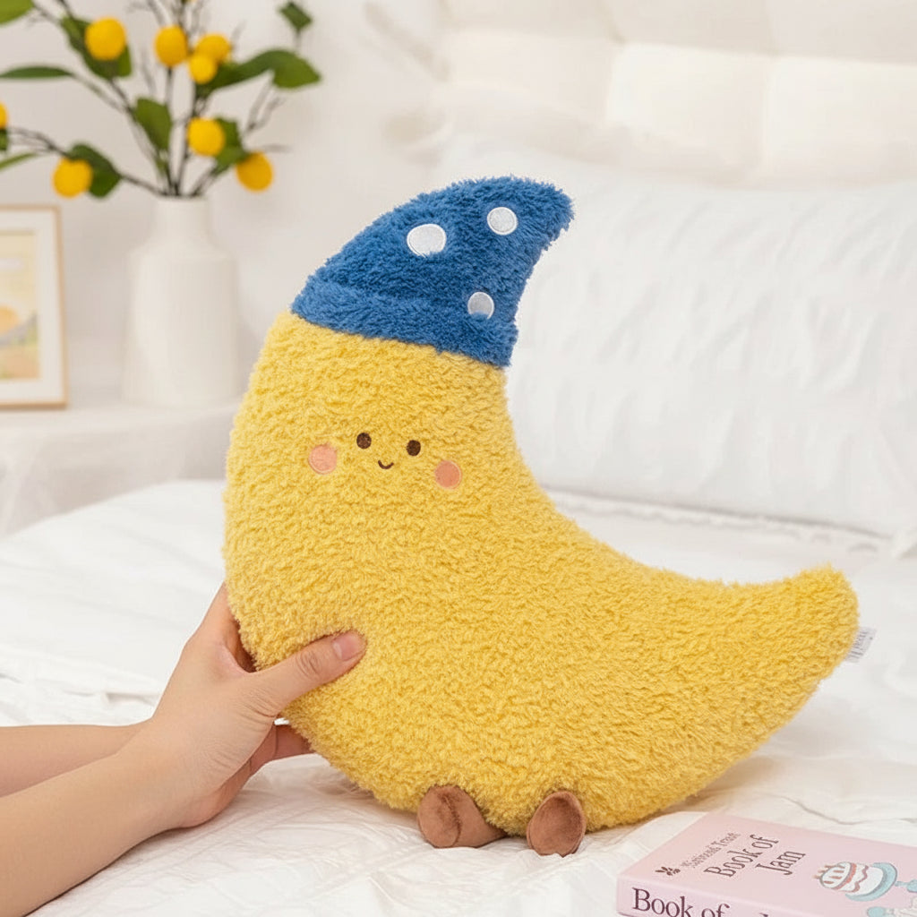 Yellow moon-shaped kawaii plush pillow with a blue top on a white background