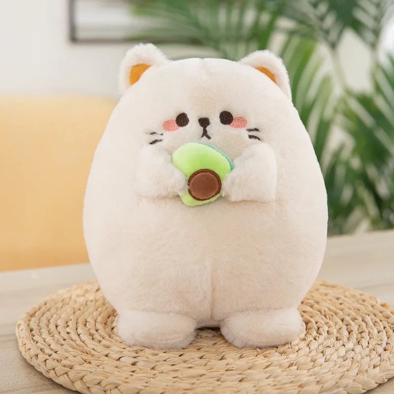 White kawaii plush toy resembling a cat holding an avocado on a woven mat with a blurred indoor background