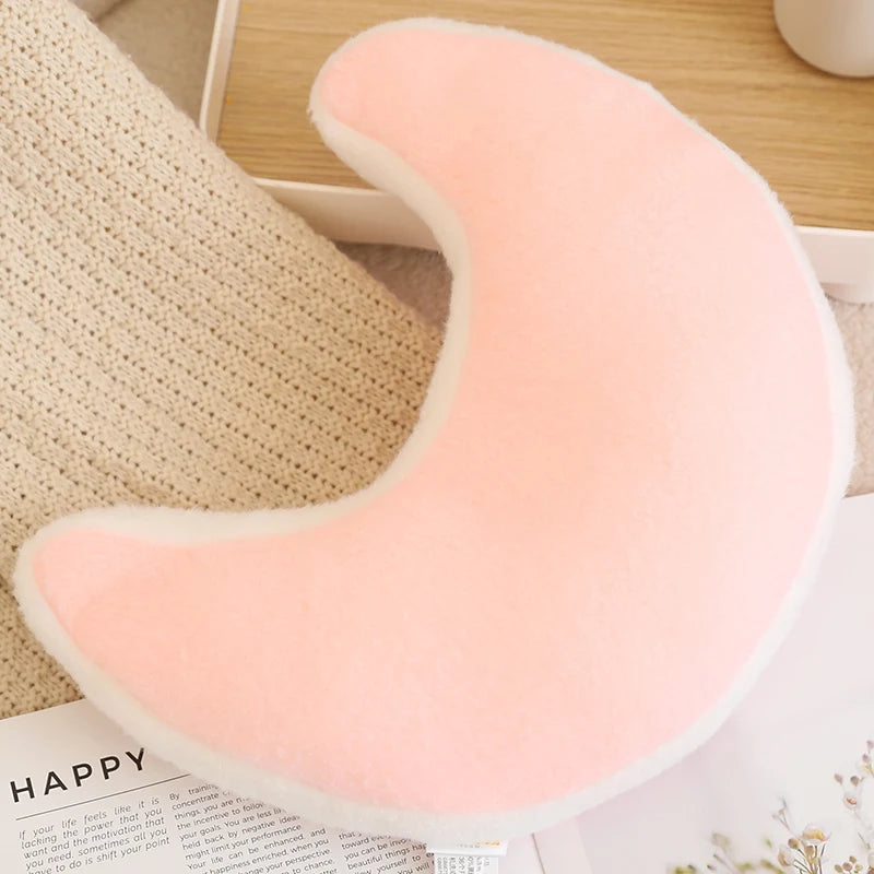 Pink U-shaped kawaii pillow on a textured surface
