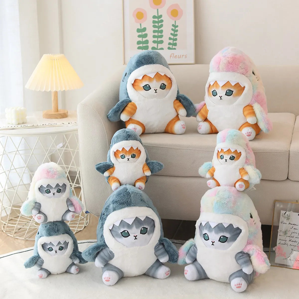 Stack of kawaii plush toys resembling penguins and cats on a couch