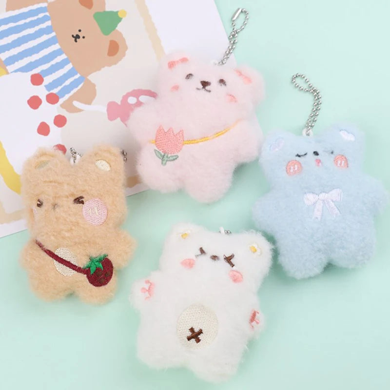 Four kawaii plush keychains on a light green background
