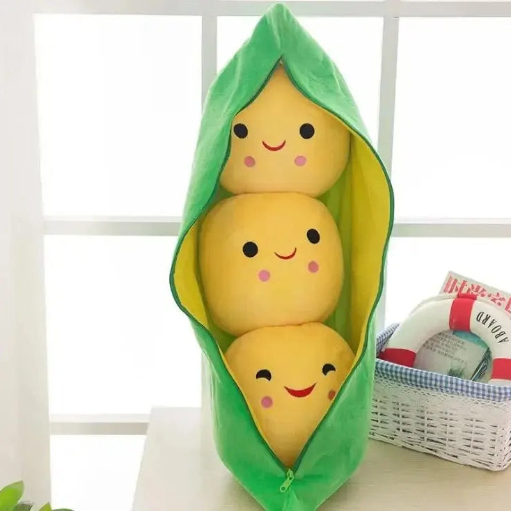 Kawaii plush toy shaped like a stack of three yellow avocados in a green shell on a light background.