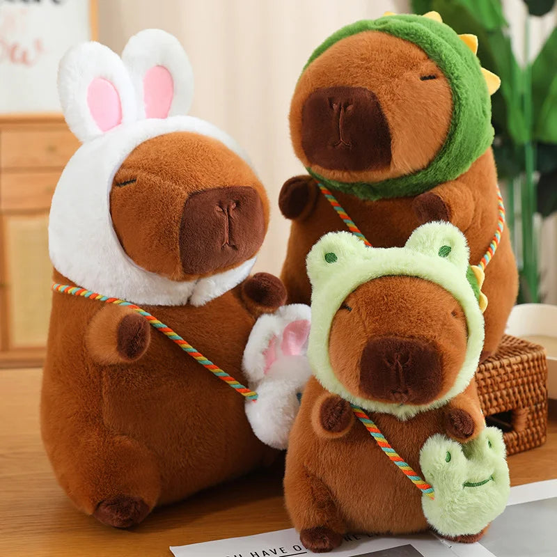Three brown kawaii plush toys with animal-themed hats on a wooden surface.