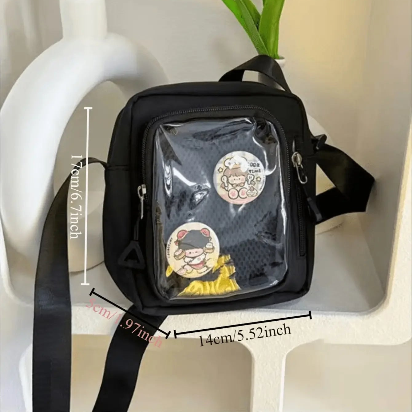 Black Kawaii crossbody bag with clear front pocket on a white surface with measurements displayed.