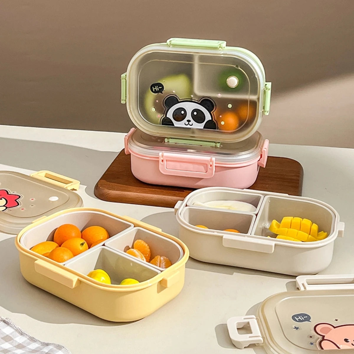 Set of kawaii bento boxes with compartments containing fruits on a neutral background