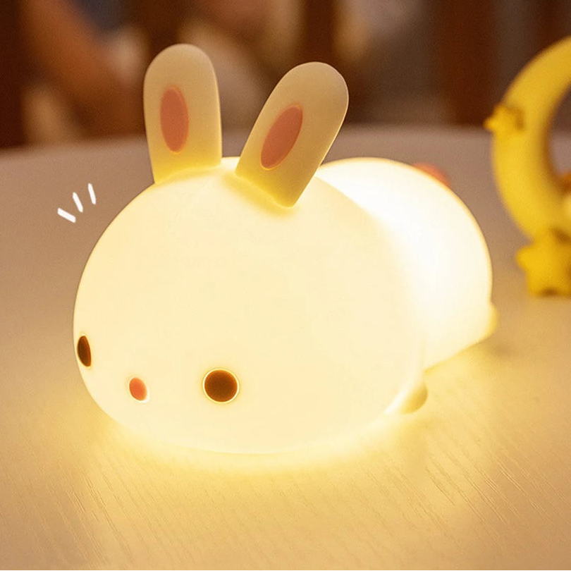 Cute rabbit-shaped kawaii night light on a wooden surface