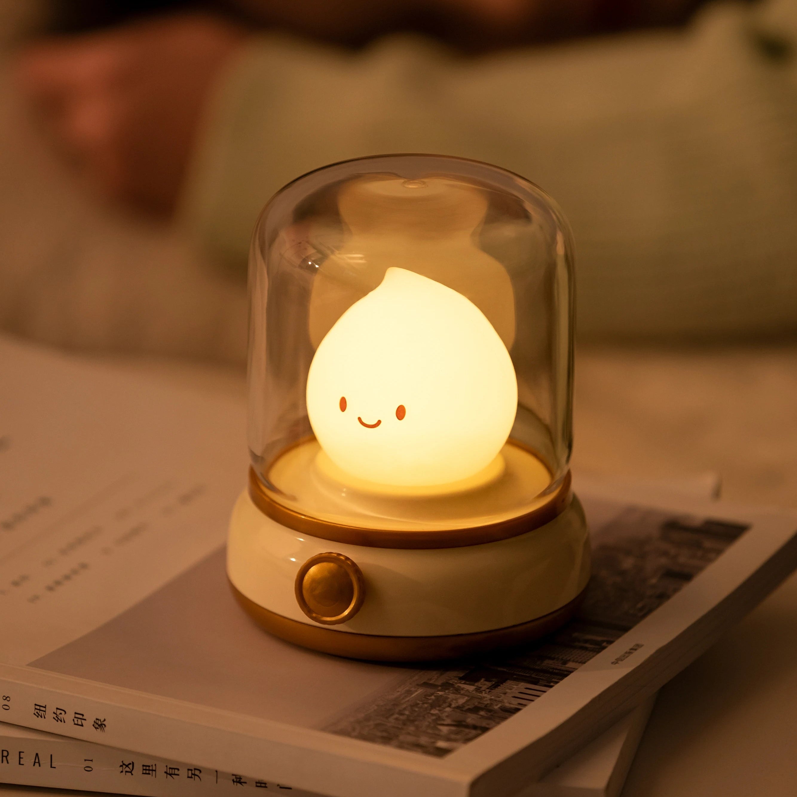 Cute kawaii lamp with a smiling face on a book
