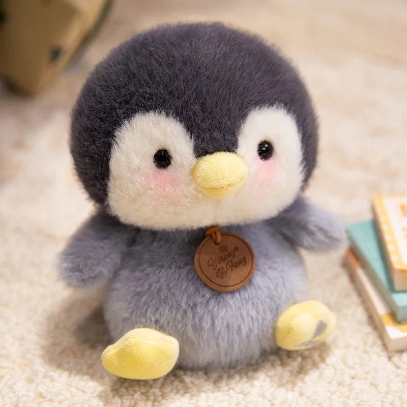 Plush penguin kawaii toy with a tag on a soft surface
