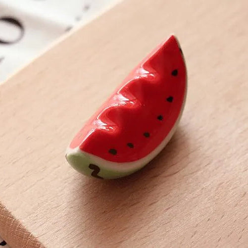 Kawaii watermelon slice-shaped object on a textured surface