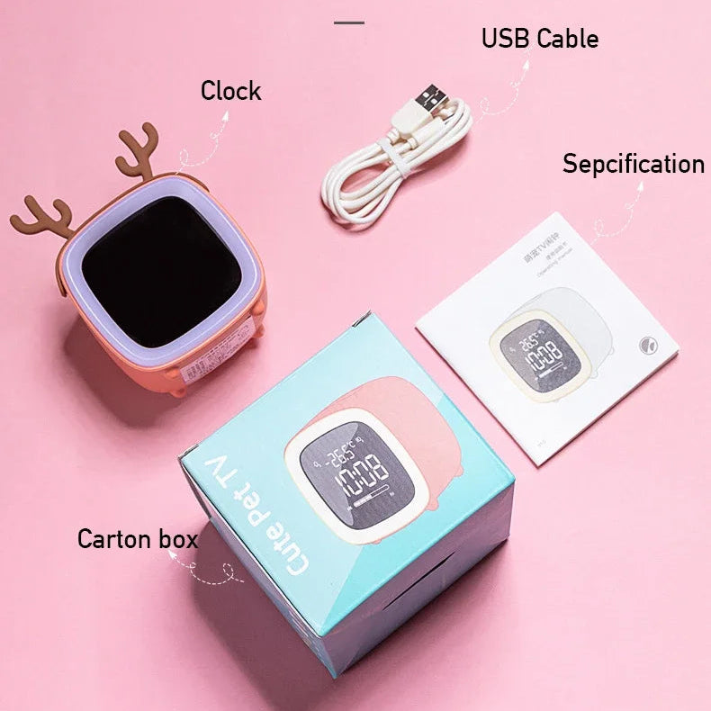 Product packaging with kawaii clock, USB cable, and specification sheet on a pink background