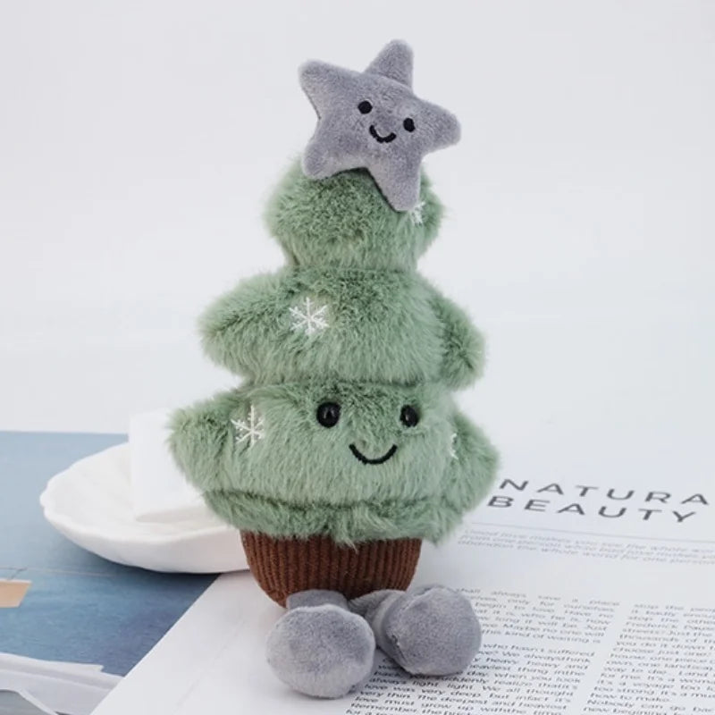 Plush toy shaped like a kawaii Christmas tree with a star on top, sitting on a surface with text.
