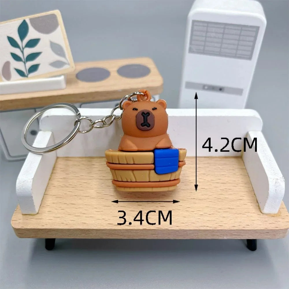 Bear-shaped kawaii keychain on a wooden stand with measurements indicated