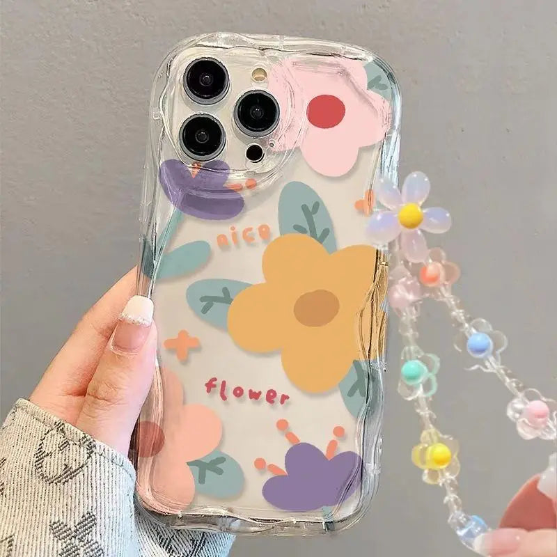 Phone case with floral kawaii design and lanyard held by a hand against a gray background