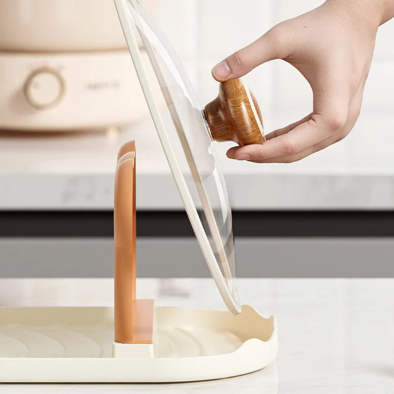 Person pouring liquid from a wooden kawaii-style container into a white and brown device on a light background