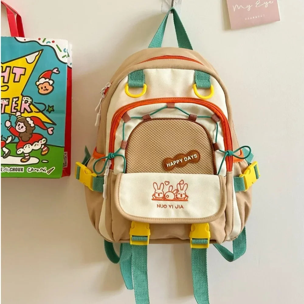 Children's Kawaii backpack with colorful straps hanging on a wall