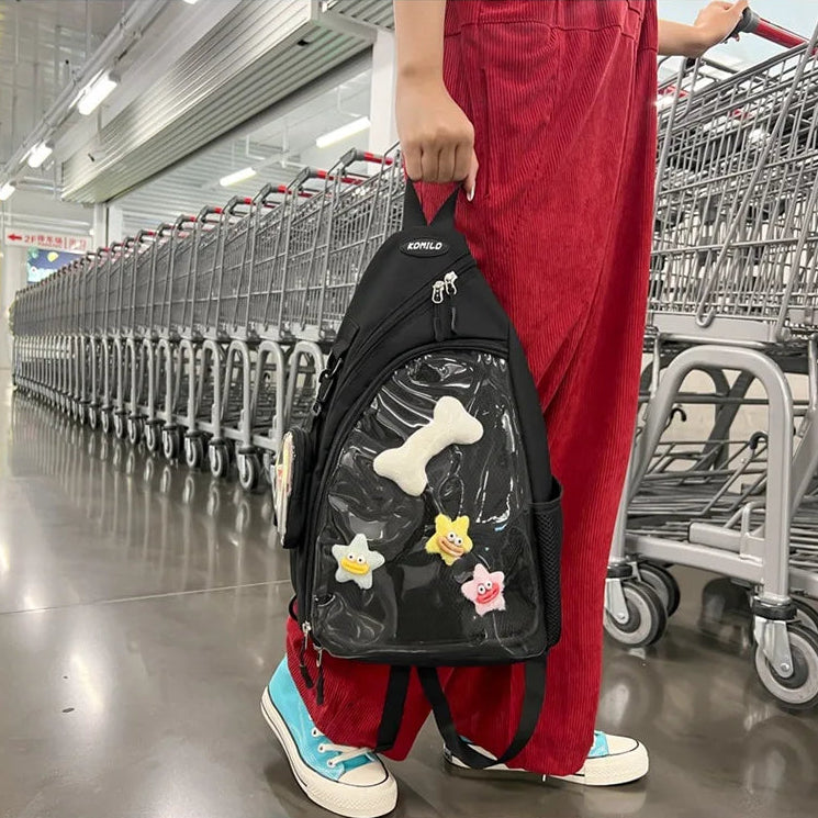 Person wearing a black Kawaii backpack with colorful designs in a shopping mall.