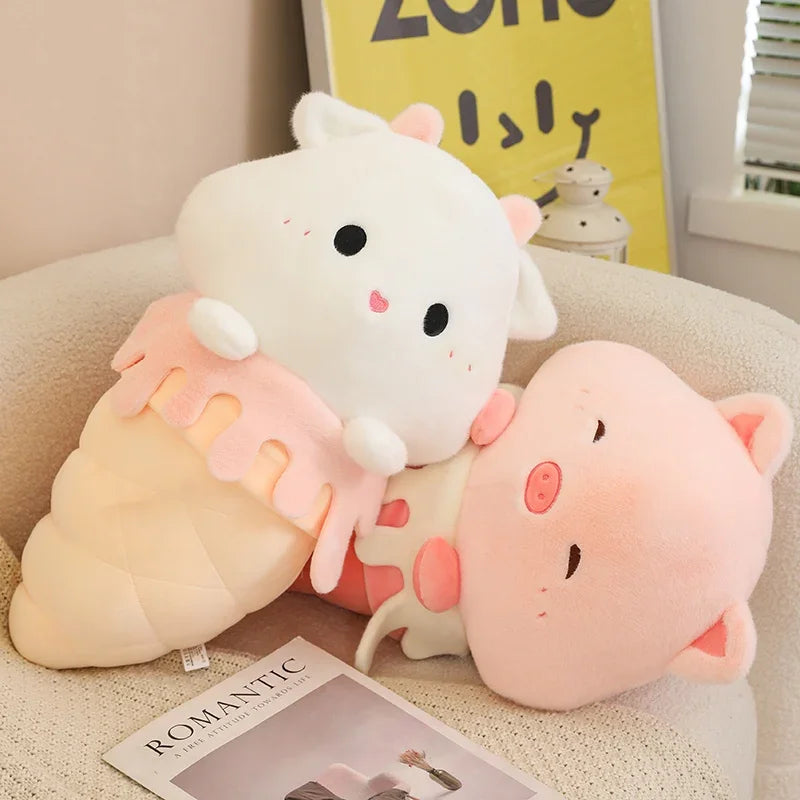 Two cute kawaii plush toys resembling a sheep and a pig on a cushion with a magazine underneath.
