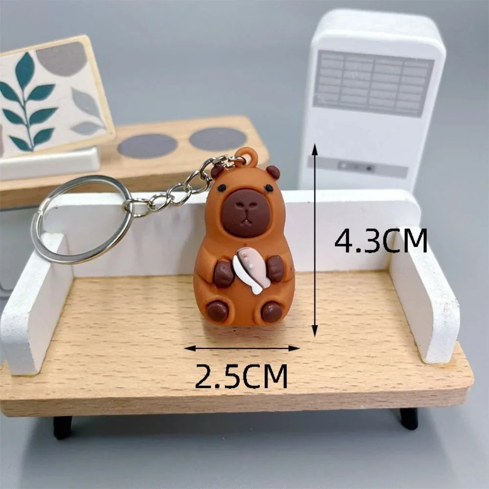 Brown bear-shaped kawaii keychain with measurements on a wooden stand
