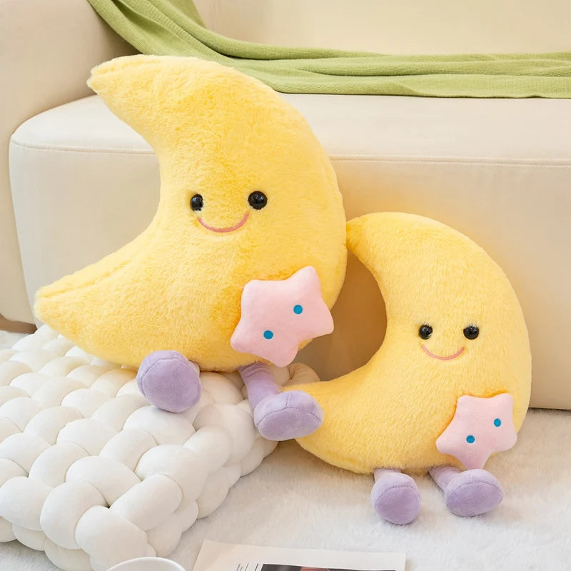 Two yellow kawaii plush toys shaped like moons with smiling faces on a beige couch.