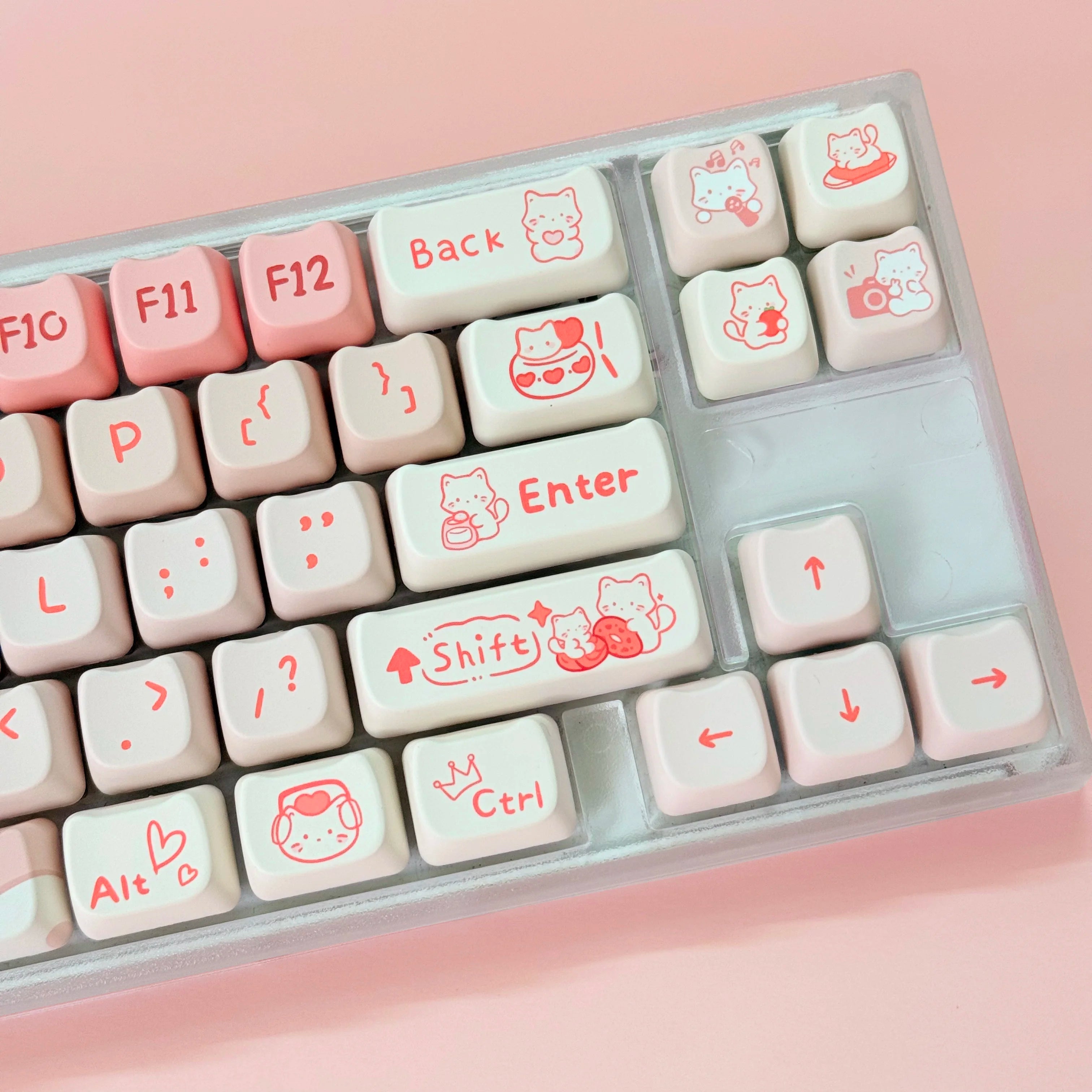 Keyboard keys with Kawaii designs on a pink background