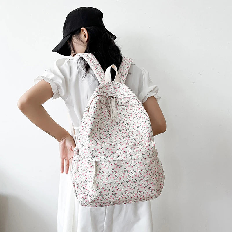 Person wearing a white Kawaii floral drawstring bag against a plain background