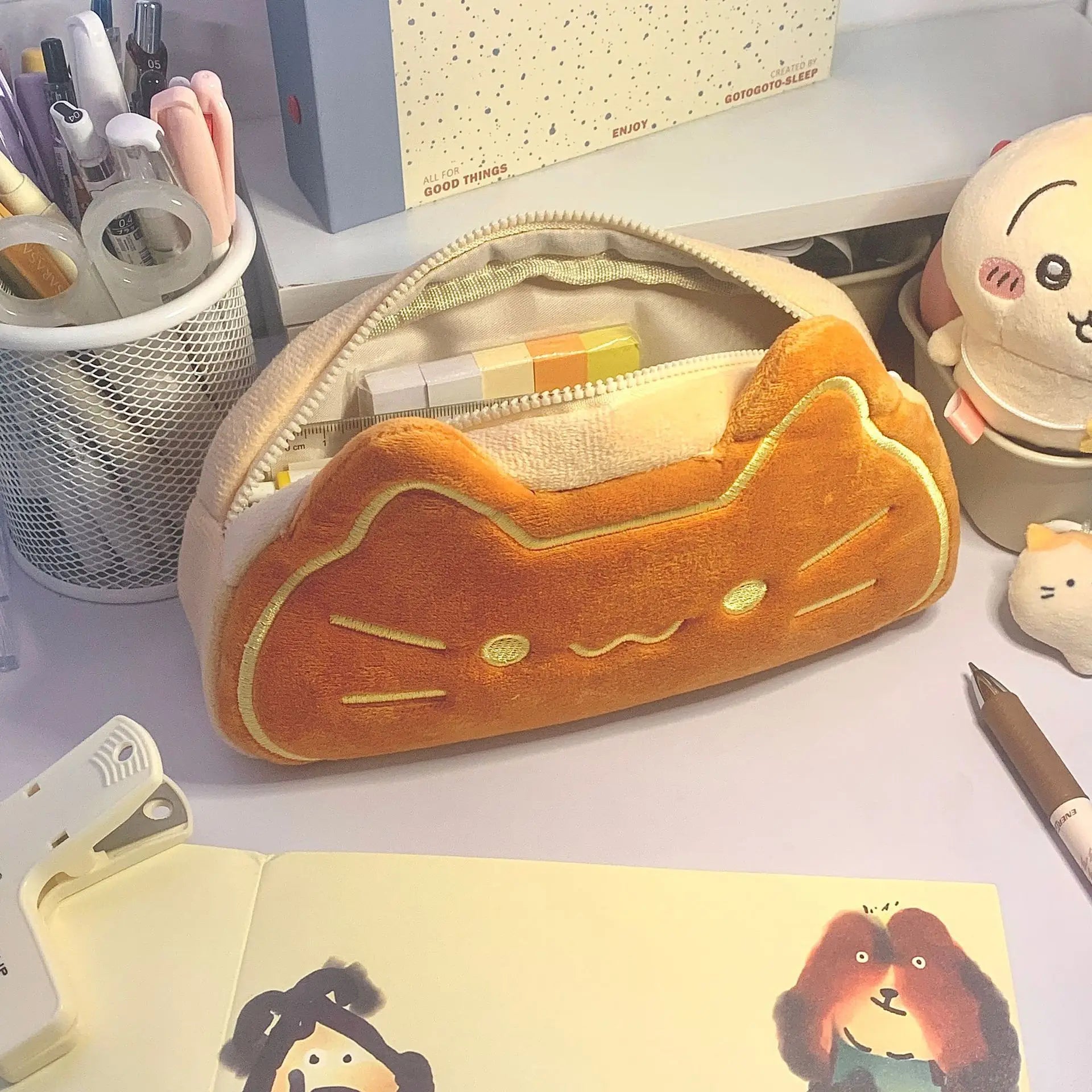 Cat-shaped kawaii pencil case on a desk with stationery items