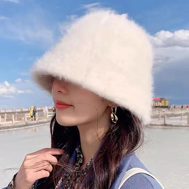 Person wearing a Kawaii white fur hat with a scenic background