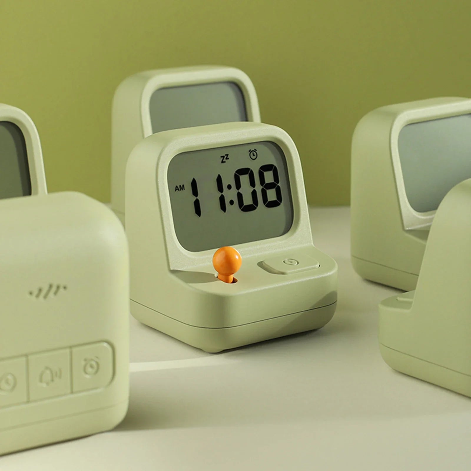 Set of light green kawaii alarm clocks on a neutral background