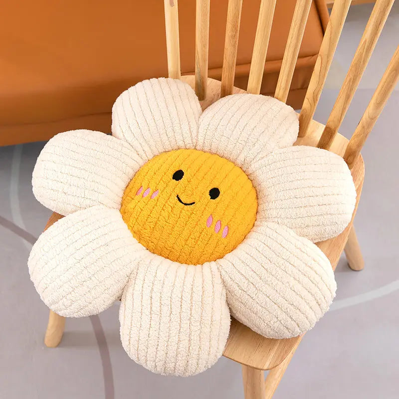 Flower-shaped kawaii cushion with a smiling face on a wooden chair