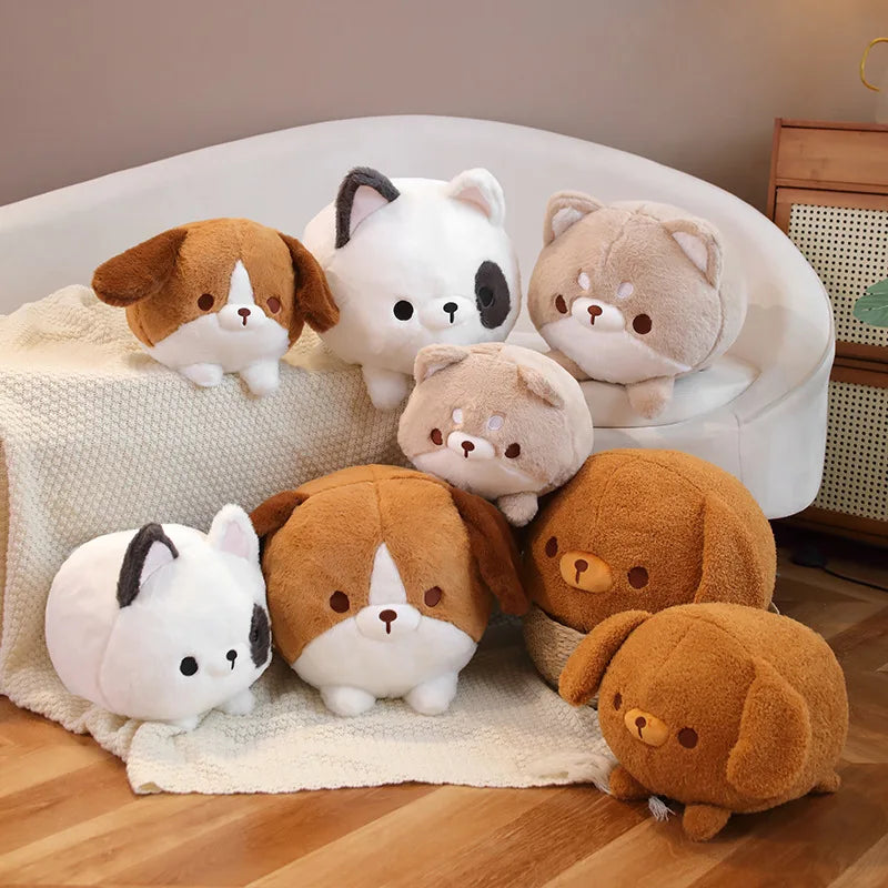 Set of kawaii plush dog and cat toys on a white cushion with a wooden floor and chair in the background.
