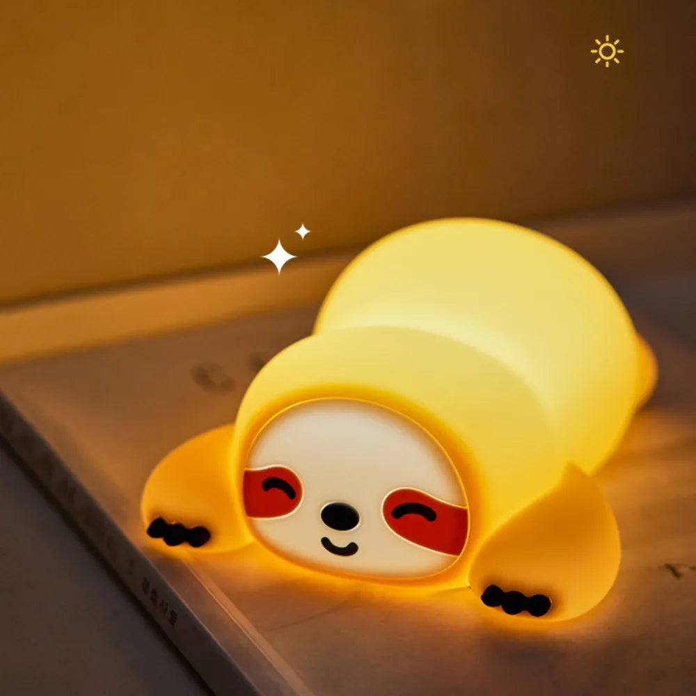 Yellow cartoon-like kawaii night light on a surface with a warm glow.