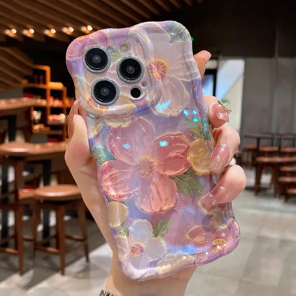 Hand holding a phone case with kawaii floral design in a blurred indoor setting