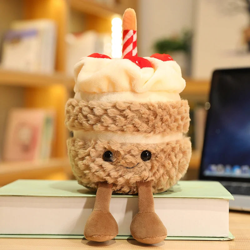 Plush kawaii toy resembling a layered dessert with a candle on a book
