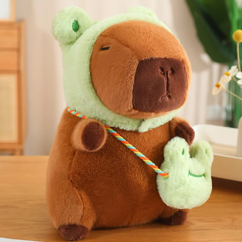 Kawaii plush toy bear in a green costume on a wooden surface