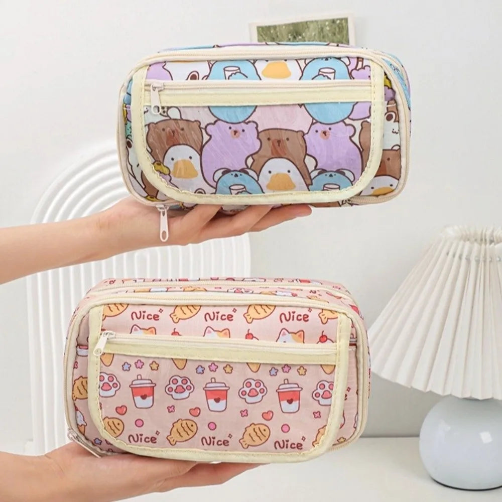 Two small pouches with kawaii cute patterns held by a hand against a neutral background