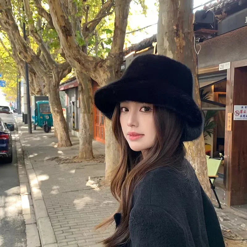 Woman wearing a Kawaii black hat on a street with trees and buildings in the background
