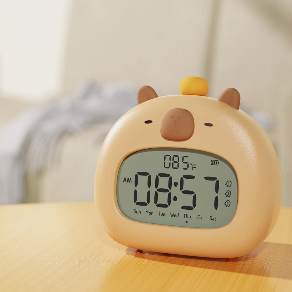 Cute animal-shaped kawaii digital clock on a wooden surface with a blurred background