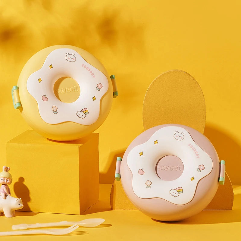 Two round, kawaii donut-shaped cushions with cartoon designs on a yellow background