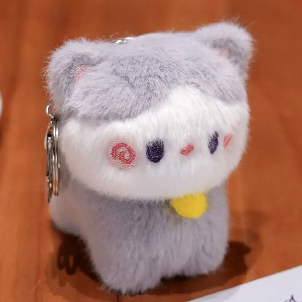 Kawaii plush keychain with a cat design on a wooden surface
